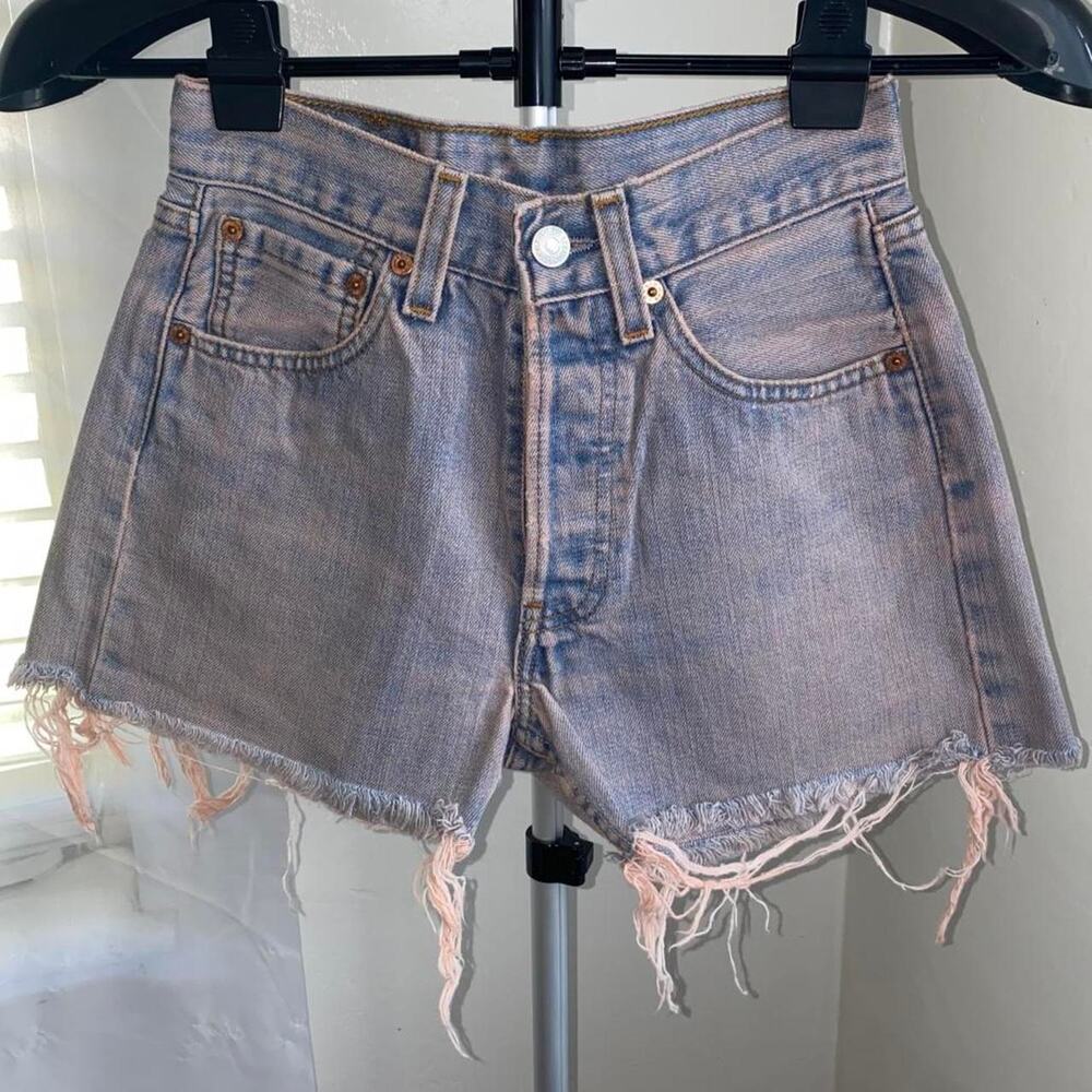 vintage women's Levi's blue denim shorts with pink wash frayed hem